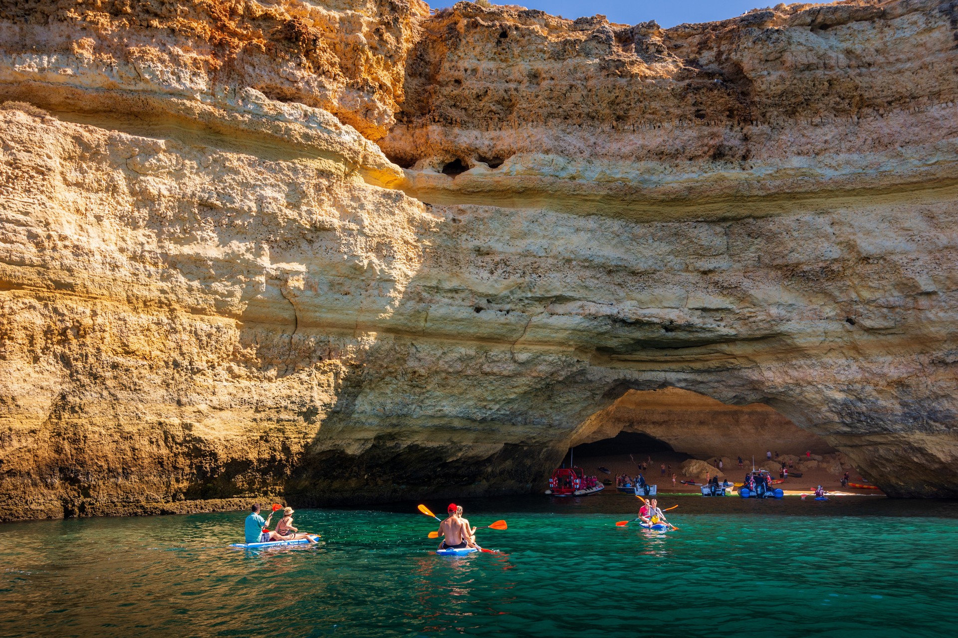 Tourists kayaking to Benagil Cave along Algarve coast in Portugal