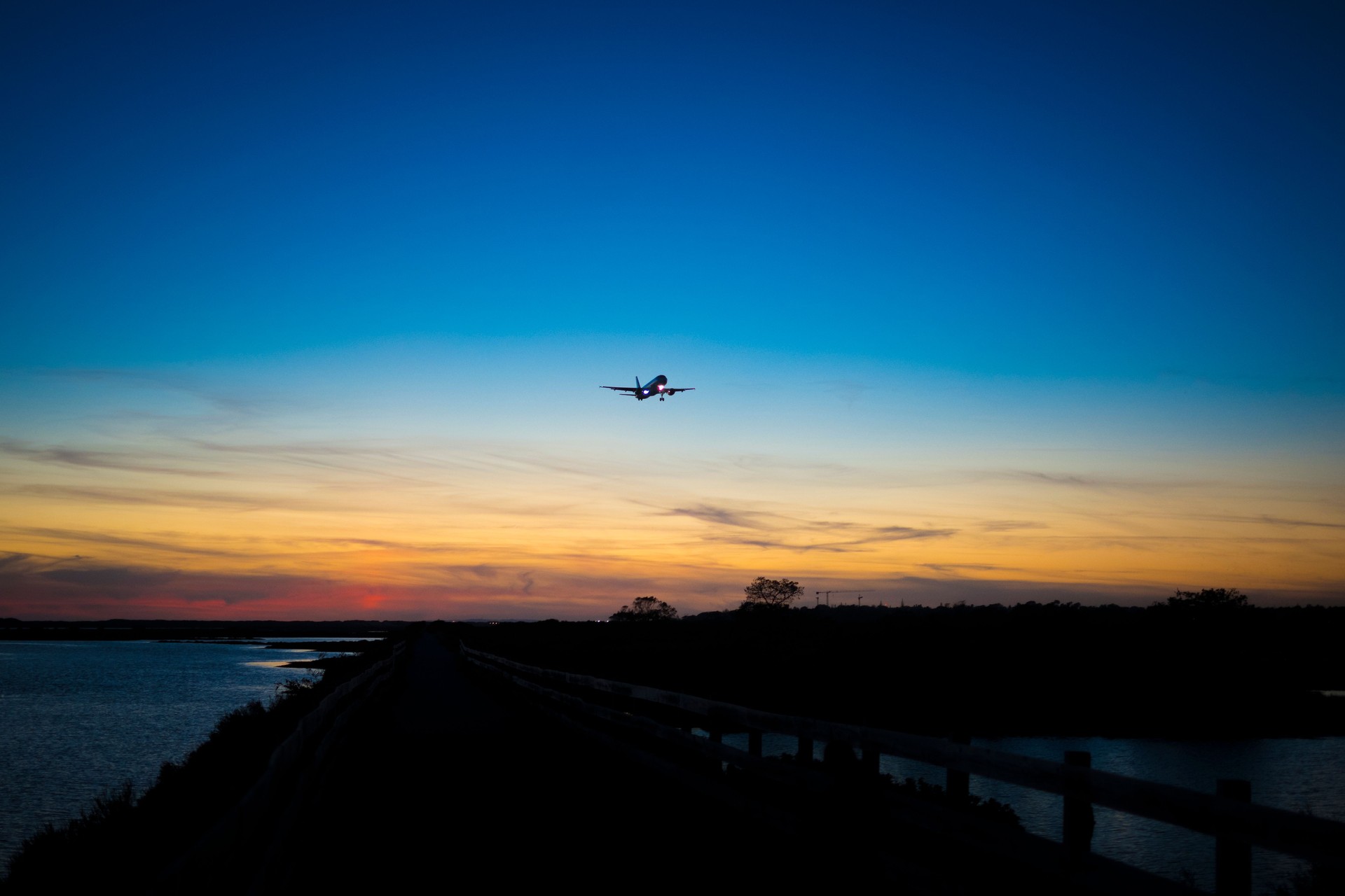 Airplane approaching the airport of Faro, over Ria Formosa natural park during sunset